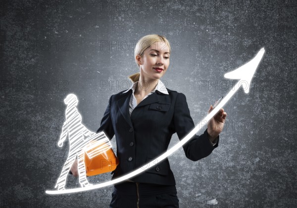 Business lady drawing success graph of professional career. Strategy planning and development of personal growth. HR specialist in business suit with safety helmet. Recruitment agency assistance