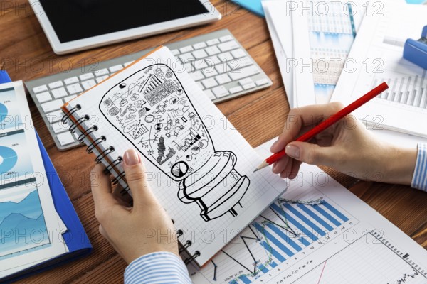 Close-up, woman draws business notes in her notebook. Business Innovation Concept