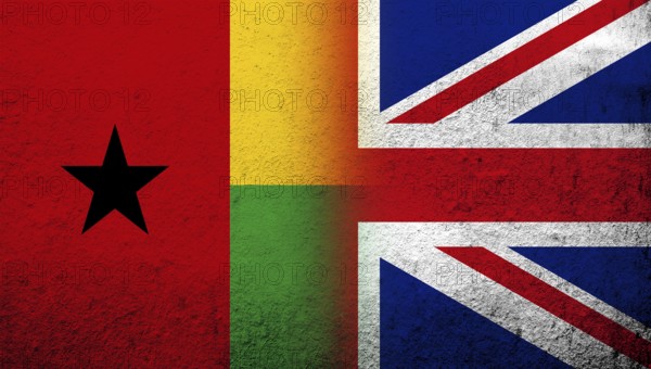 National flag of United Kingdom (Great Britain) Union Jack with The Republic of Guinea-Bissau National flag. Grunge background