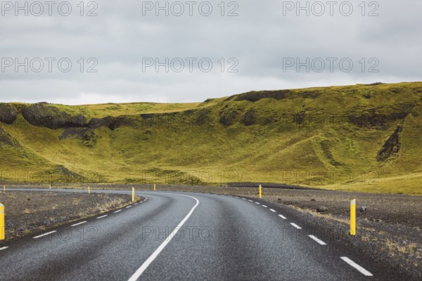 Road and mountain view during road trip in iceland. Foggy landscape in autumn time.