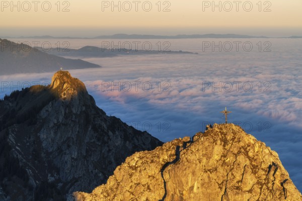 Peaks im Ammergauer Alpen alps at sunrise, above the clouds in the valley