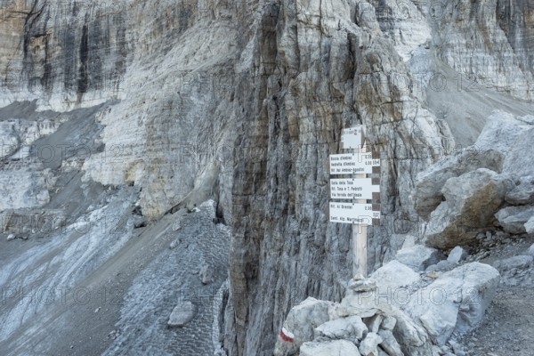 Trekking direction indicators. Tourist paths directions and travel time shown on a traditional direction signs at the Dolomiti mountains, Italy, Europe