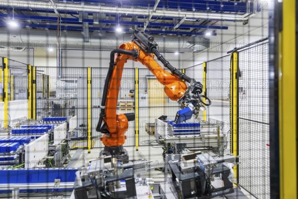 JT Energy Systems is the largest production centre for lithium-ion batteries in the intralogistics industry. On an area of 42, 000 m², lithium-ion batteries are produced and reconditioned to the highest quality standards using modern production technologies. An industrial robot assembles individual cells into battery units, Freiberg, Saxony, Germany, Europe