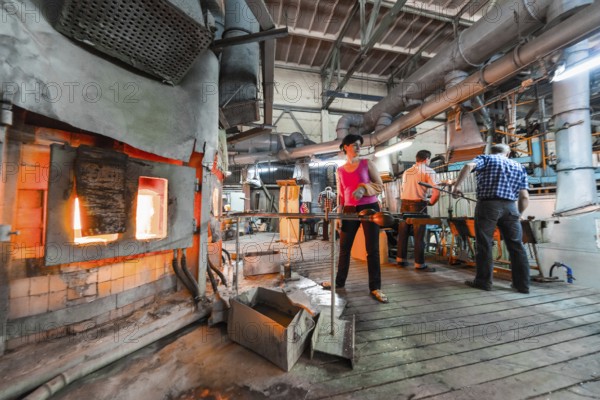 Belarus, Minsk, - March 01, 2018: Neman Glass factory. Glass factory workers on manufacture background working with industry equipment, Europe