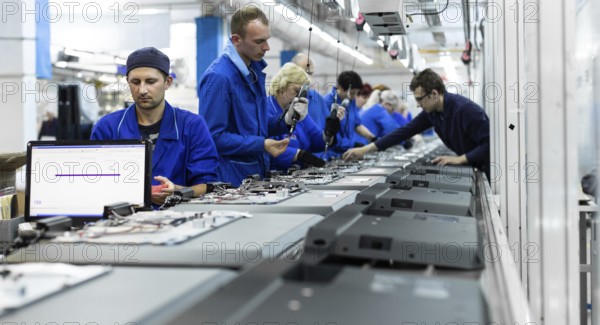 Conveyor for the production of television sets. Testing TVs in the workshop. Electronics Assembly Line