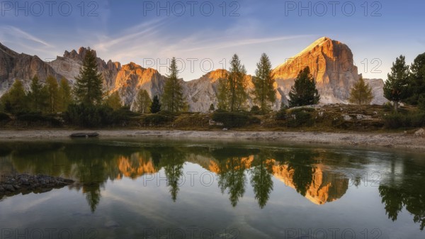 Panorama of the lake Lago di Limedes with the reflection of the surrounding mountains