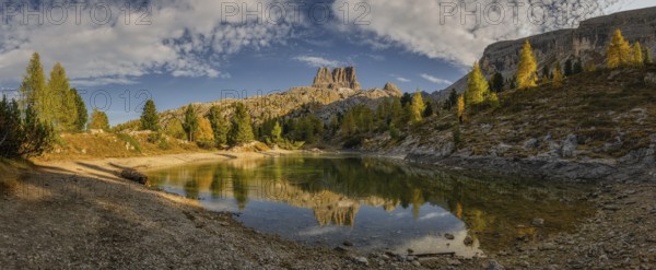 Panorama of the lake Lago di Limedes with the reflection of the surrounding mountains