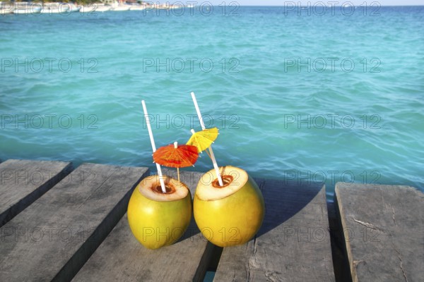 Coconut coktails in caribbean on wood pier turquoise sea