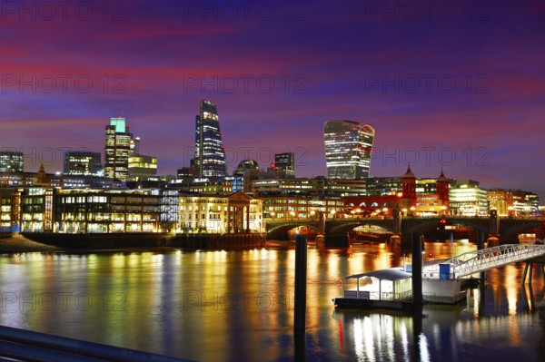 London skyline sunset on Thames river reflection at UK