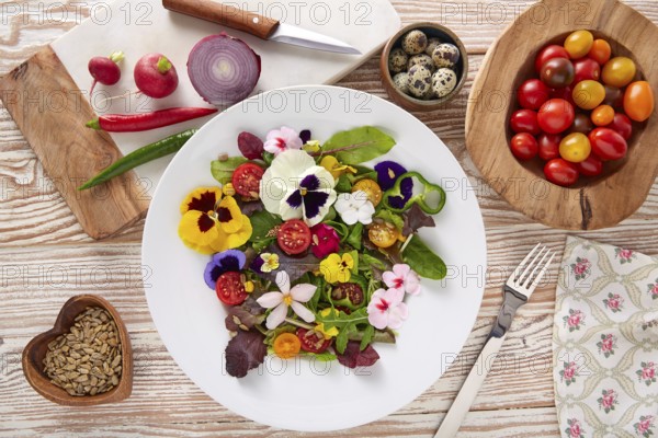 Edible flowers salad in a plate with ingredients