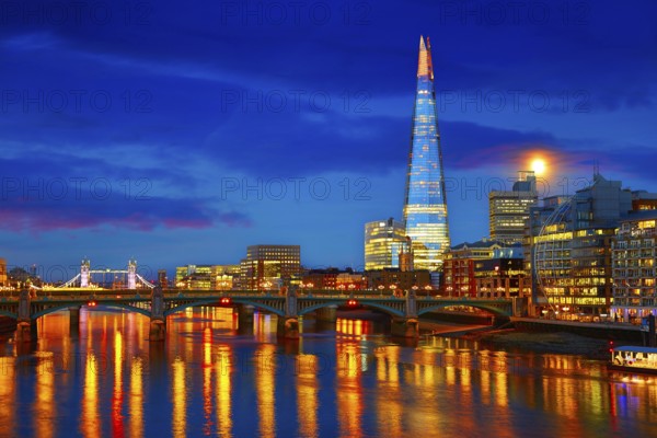 London skyline sunset on Thames river reflection at UK