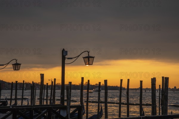 Morning atmosphere at sunrise, gondola jetty, lanterns, Venice, Italy, Europe