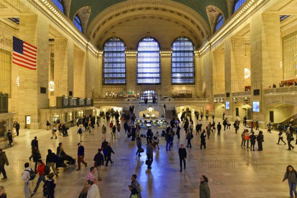 People moving through a large railway station concourse under a cool glow of light, Manhattan, Brooklyn, New York City, New York, USA, North America