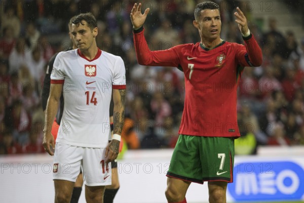 Football match, captain Cristiano RONALDO CR7 Portugal right. protests angrily with raised arms and hands towards referee Donatas RUMSAS Lithuania not to be seen, left. Jakub KIWIOR Poland looks sad and resigned to the bottom left, Estadio do Dragao, Porto, Portugal, Europe