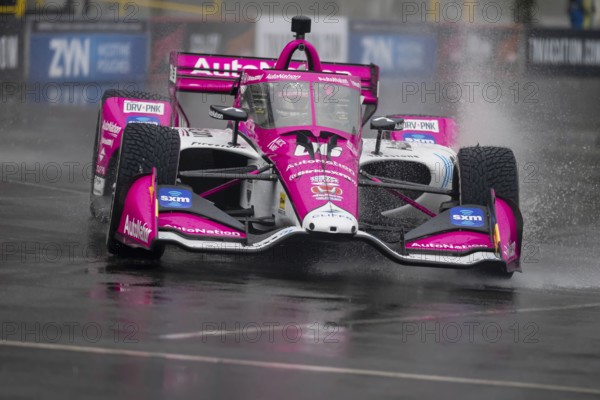 INDYCAR Series driver, HELIO CASTRONEVES (06) of Sao Paulo, Brazil, travels through the turns during a wet and dangerous practice session for the Big Machine Music City Grand Prix at Streets of Nashville in Nashville TN, South America