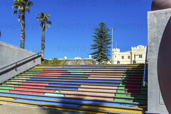 Multi-colored picturesque staircase descends to the port. Cape Town is a fabulous port city on the shores of two oceans. Mysterious South Africa. The concept of active, exotic and photo tourism