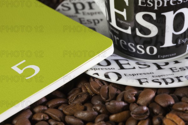 Coffee beans, cup of coffe and diary for May