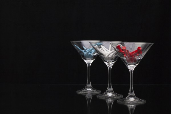 Three glasses of champagne with golf tees