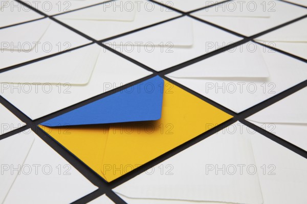 Composition with white and colored envelopes on the table. The photo suitable for various holidays and anniversaries