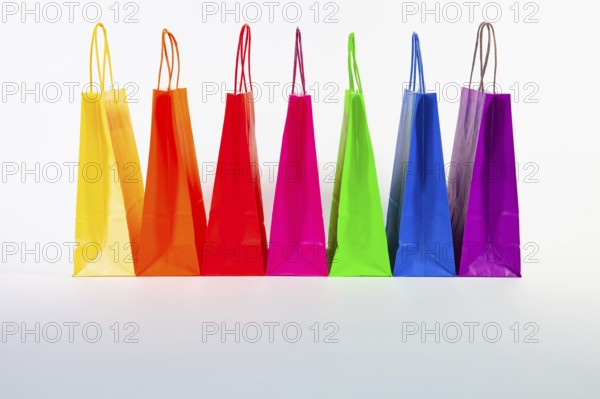 Set of colorful empty shopping bags isolated on the white background. Sale, consumerism, advertisement and retail concept. Many colorful shopping bags