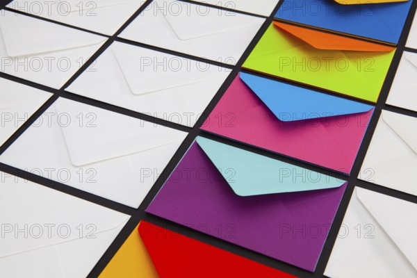 Composition with white and colored envelopes on the table. The photo suitable for various holidays and anniversaries