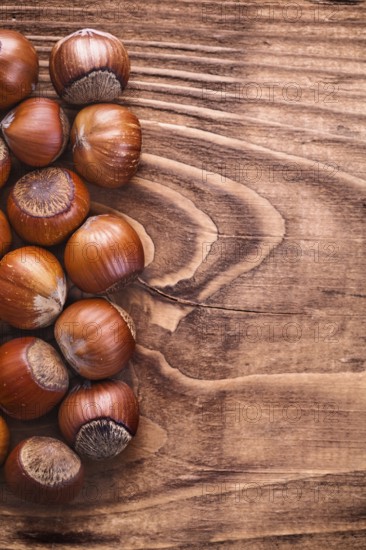 Hazelnuts on vintage wooden board food and drink concept