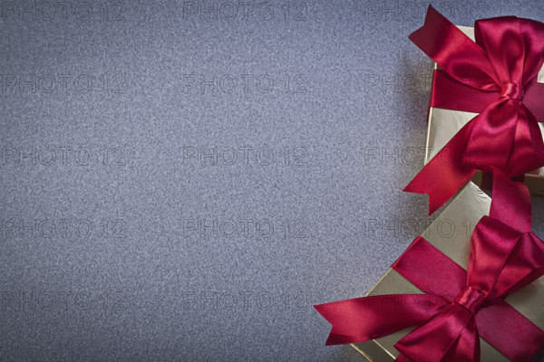 Giftboxes with red tapes on grey background holidays concept