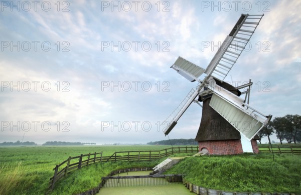 Dutch windmill during cloudy summer morning, Netherlands