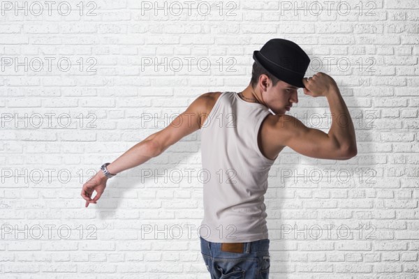 Hip young man wearing a hat dancing
