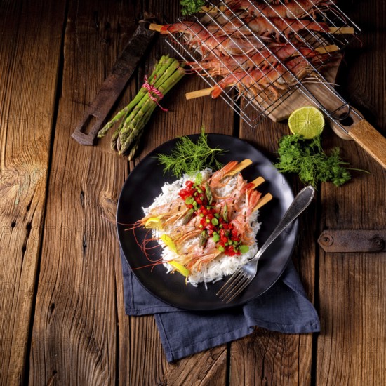 Grilled red argentine shrimps with red salsa and green asparagus