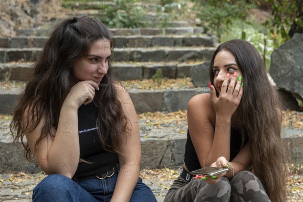 Young happy and beautiful young women smiling and chatting
