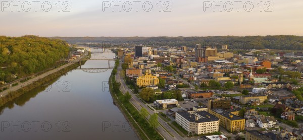 Sunrise reflects in the Kanawha River slowly flowing by picturesque Charleston West Virginia downtown