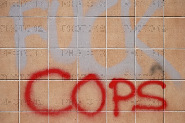 The political slogan Fuck Police on a tiled wall