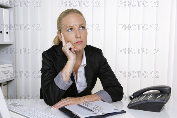 A secretary in the office at her daily work, 35 years, Thoughtful studio shot, Federal Republic of Germany