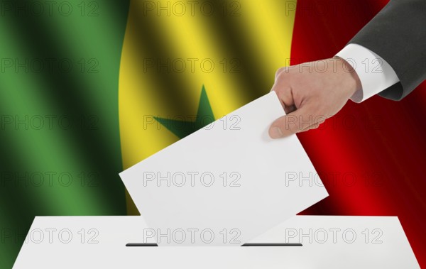 The Senegal flag and the hand with the bulletin about the ballot box