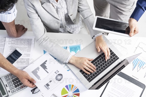 Corporate teamwork concept with businessmen. Secretary working with laptop Office desk with financial charts. Secretary working with laptop computer. Presentation and discussion of new startup project
