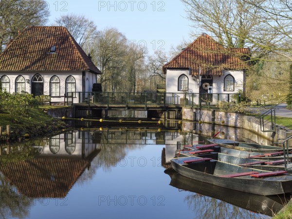 Traditional architecture and boats are reflected in the calm waters, winterswijk, gelderland, the netherlands