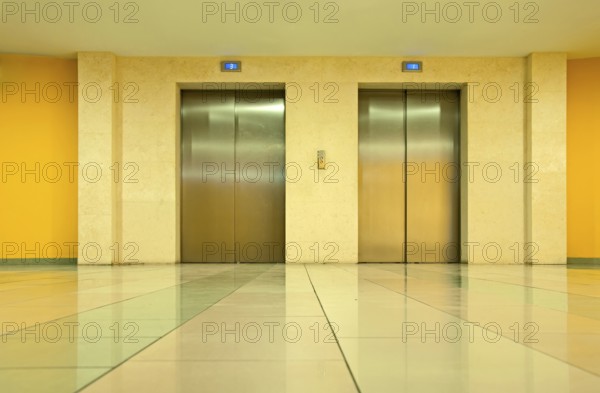 Two elevator doors in a luxurious building