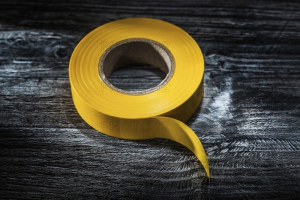Yellow electrical tape on vintage wooden board