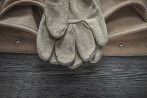 Tool belt safety gloves on wooden board