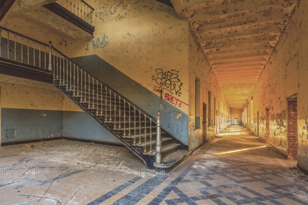 A long, deserted corridor with stairs and graffiti on the walls, Prison H11, Lost Place, Verviers, Province of Liège, Belgium, Europe