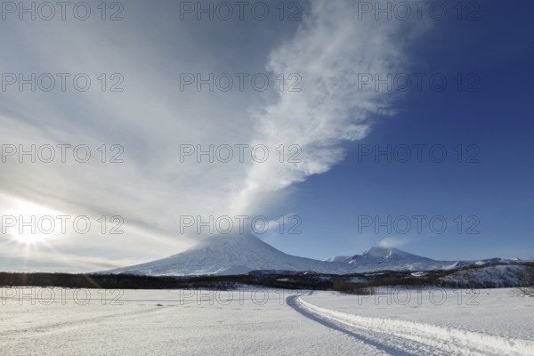 Beautiful volcanic landscape of Kamchatka Peninsula: wintry view of eruption active Klyuchevskoy Volcano (Klyuchevskaya Sopka), ejection from crater of volcano plume of gas, steam and ashes. Eurasia, Far East, Russia, Kamchatsky Krai, Europe