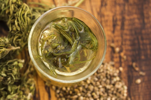 Cannabis herbal tea on wooden background