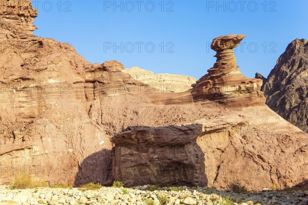 Multicolored landscape formations. Bizarre forms of weathered sandstone in the mountains. Eilat Mountains. The rocks are composed of sandstone