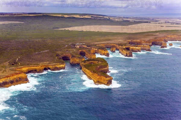 Australia. The Great Ocean Road goes along the Pacific coast. Picturesque shoreline. The picture was taken from the helicopter. The concept of extreme and active tourism