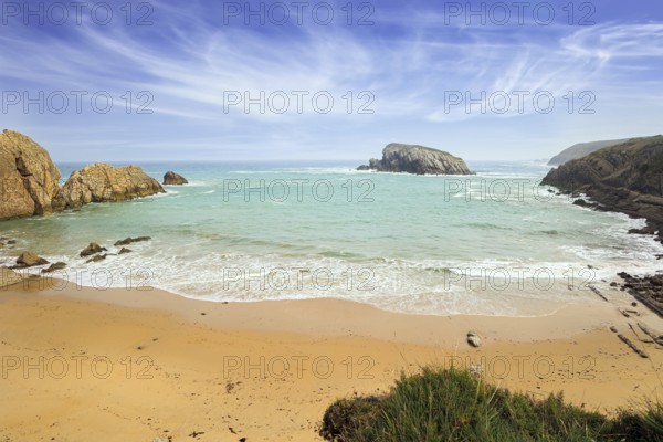 Playa de la Arnia beach. Amazing geological formations amaze tourists. Sea waves break on the coastal rocks. Snow-white sea foam glistens in the autumn sun. Cantabria, Spain, Europe