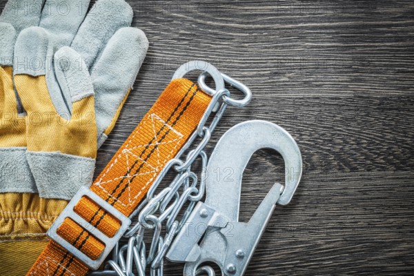 Construction gloves safety strap on wooden board