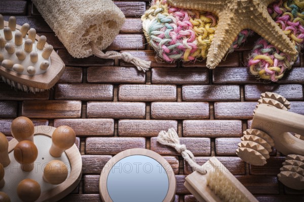 Loofah handglass massagers peeling brushes starfish and colorful bath sponge on textured wooden table mat sauna concept