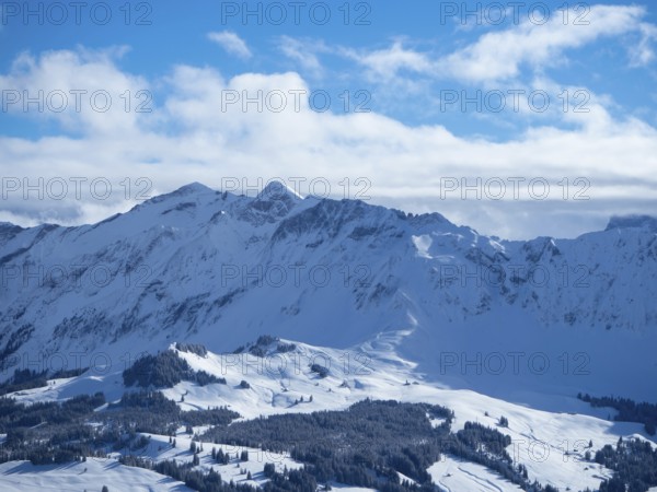 Beautiful panorama from the summit of Haengst close to Soerenberg, Switzerland. View over the karst slopes with ski traces towards the inner Alps