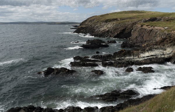 Rocky coastal area with windy waves crashing on the rocks. Atlantic Ocean. Baltimore beacon area ireland